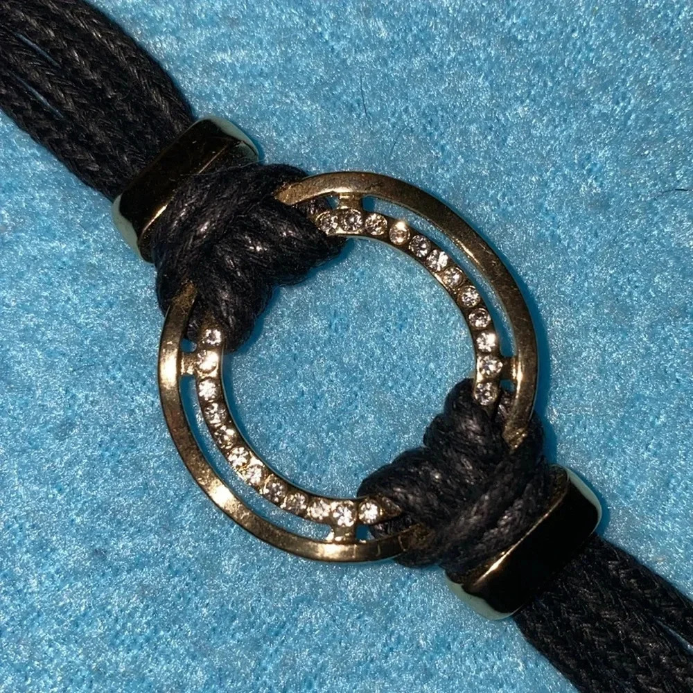 Leather strap bracelet gold tone wavy circular shape rhinestones magnetic clasp